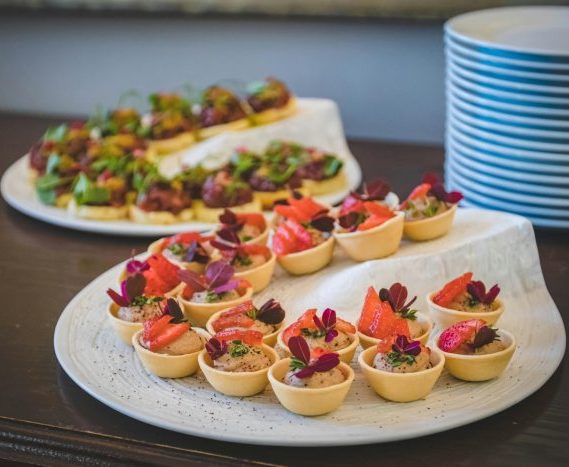 Elegant display of gourmet mini desserts with strawberries, perfect for upscale dining settings.